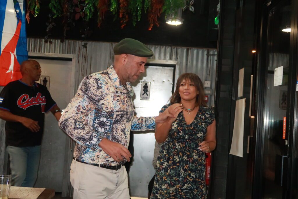 Carol contemplates whilst dancing with Andy at A Taste of Salsa Caribbean Roast event