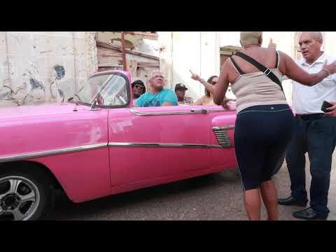 Travellers get ready to depart on Havana classic car tour