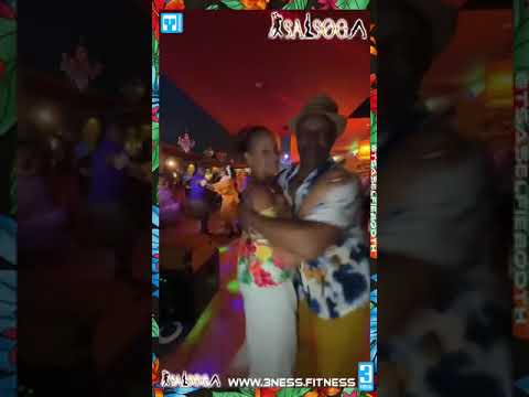 Jenni & Steevo dance in the booth during Hawaii night at SALSOGA '24