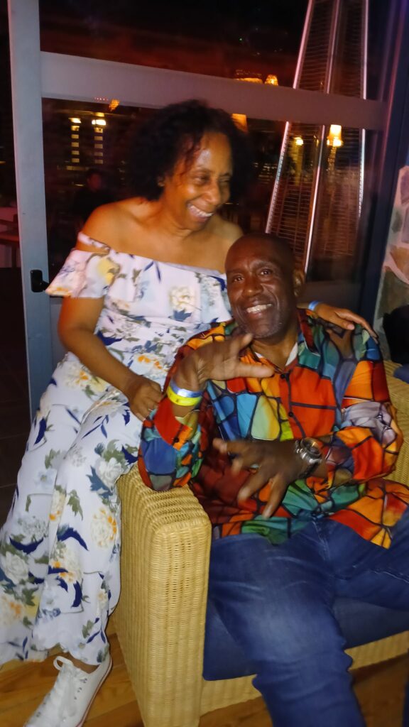 Monica is have fun, whilst Hughie poses at SALSOGA '24 Hawaii night