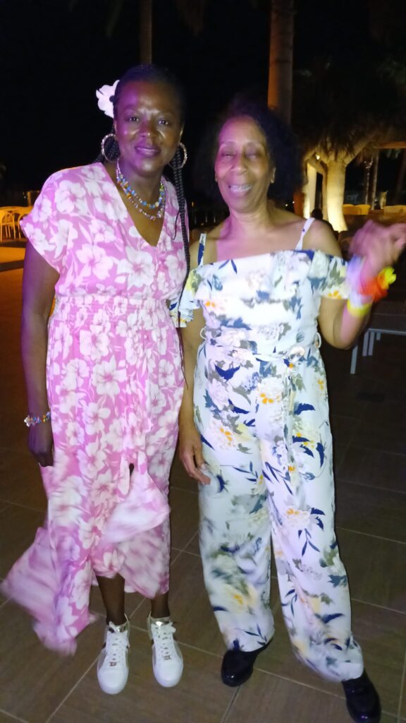 Sharon and Monica pose at SALSOGA '24 Hawaii night