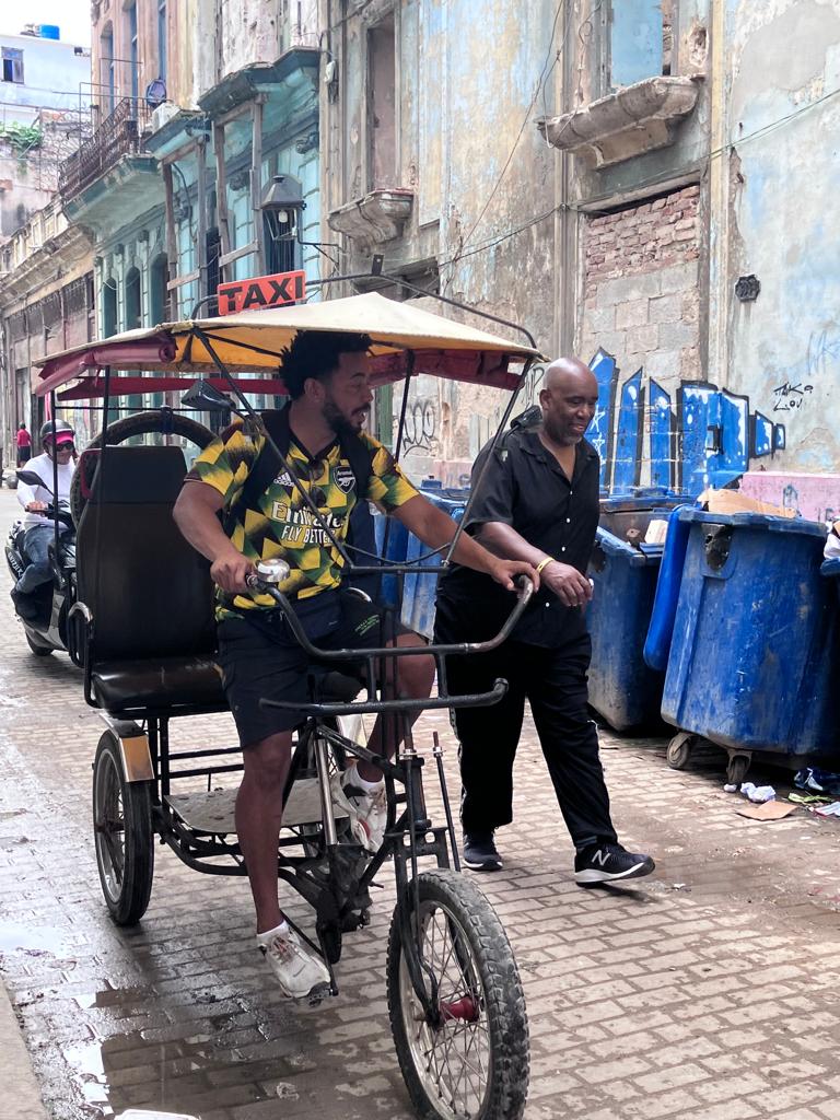Hughie chatting to Bike taxi in Havana