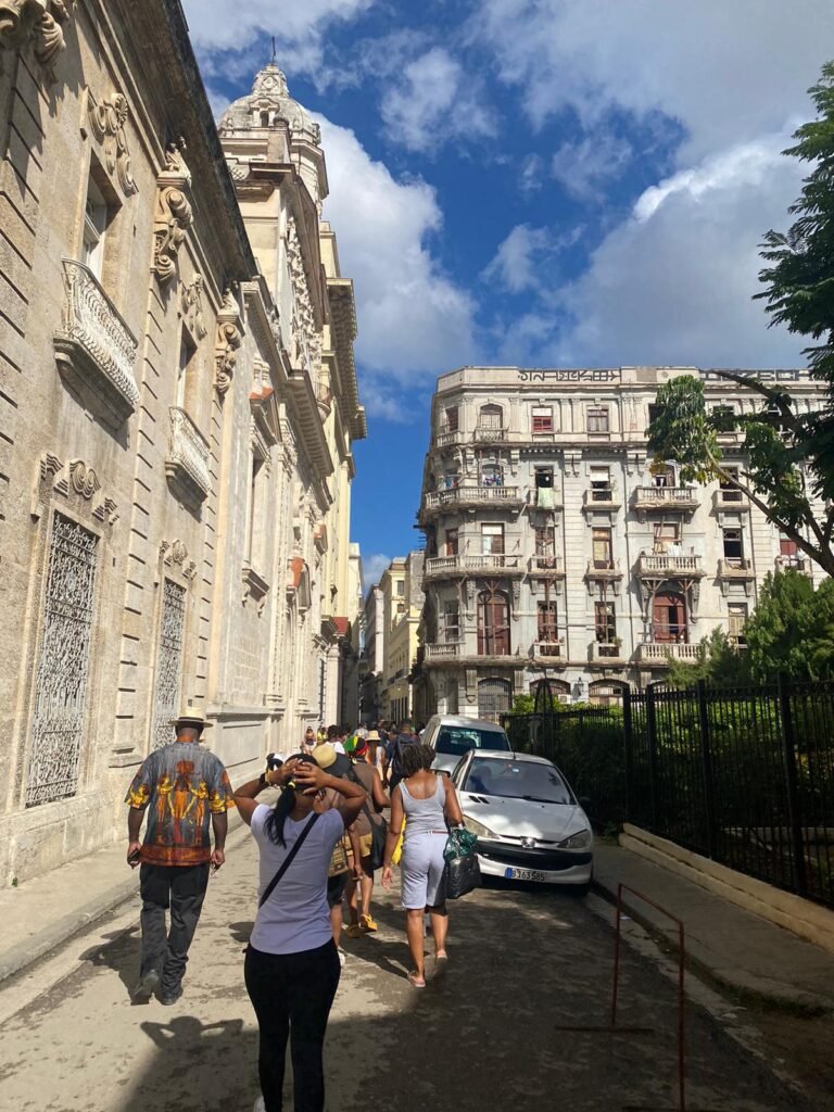 Travellers stroll down the street in Havana