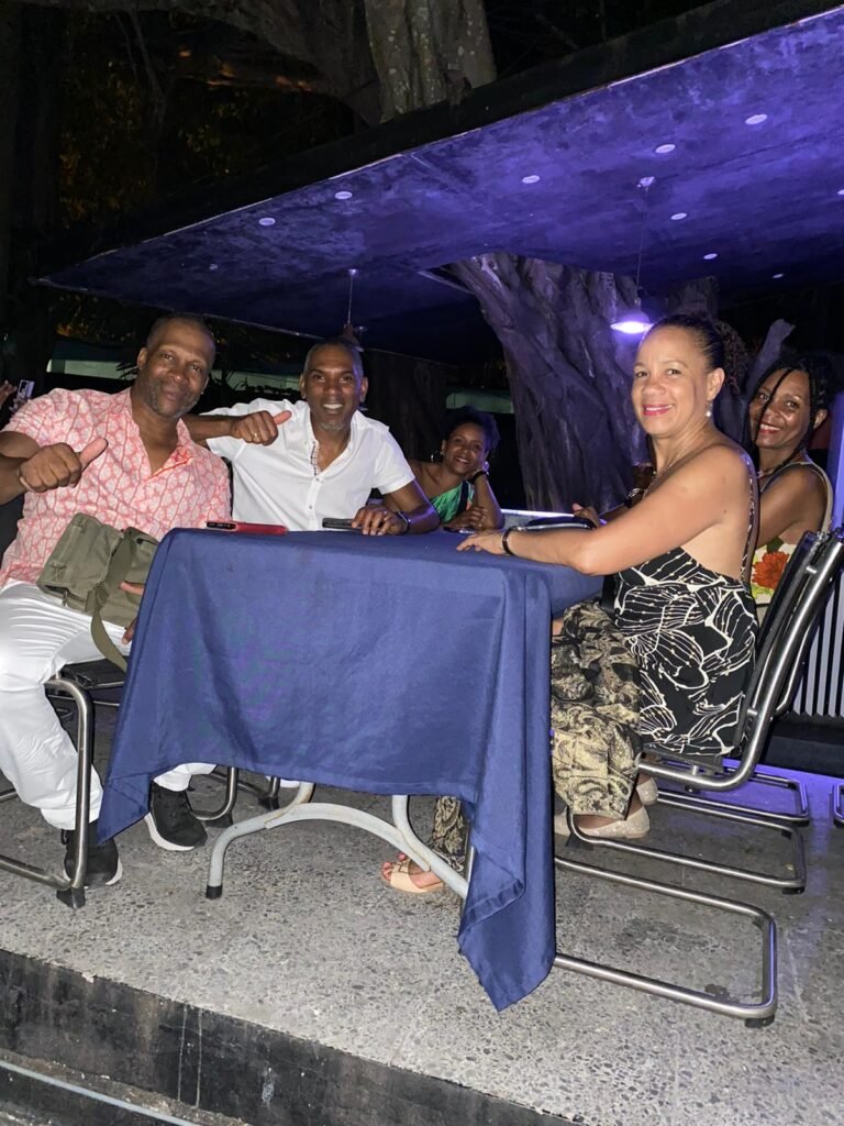 Travellers pose at night in Havana