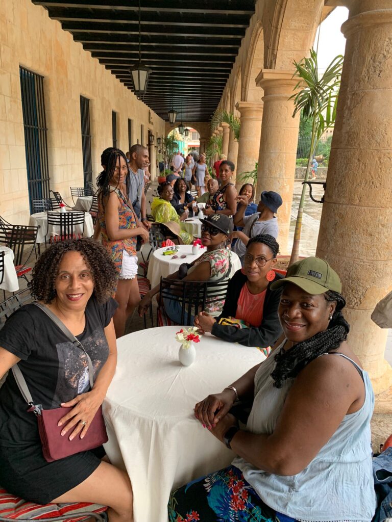 Travellers posed at lunch during Havana classic car tour