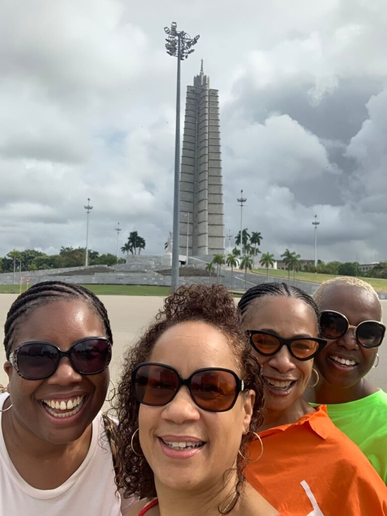 Travellers pose in Revolution square whilst on Havana classic car tour