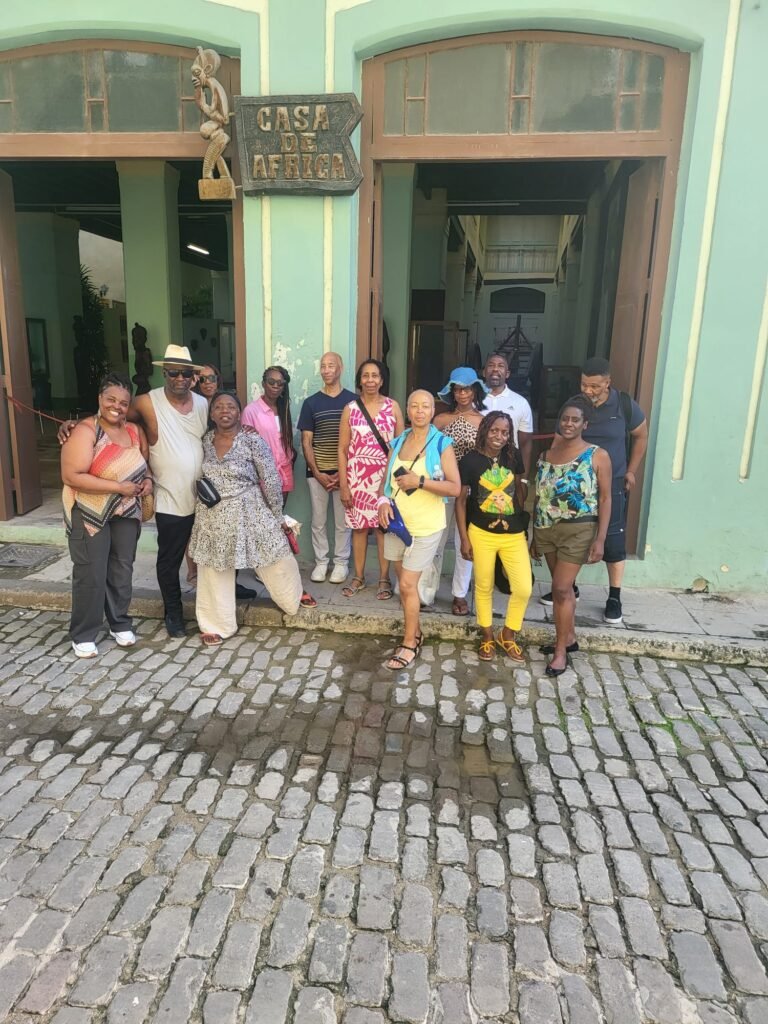 Travellers pose at Casa de Africa in Havana