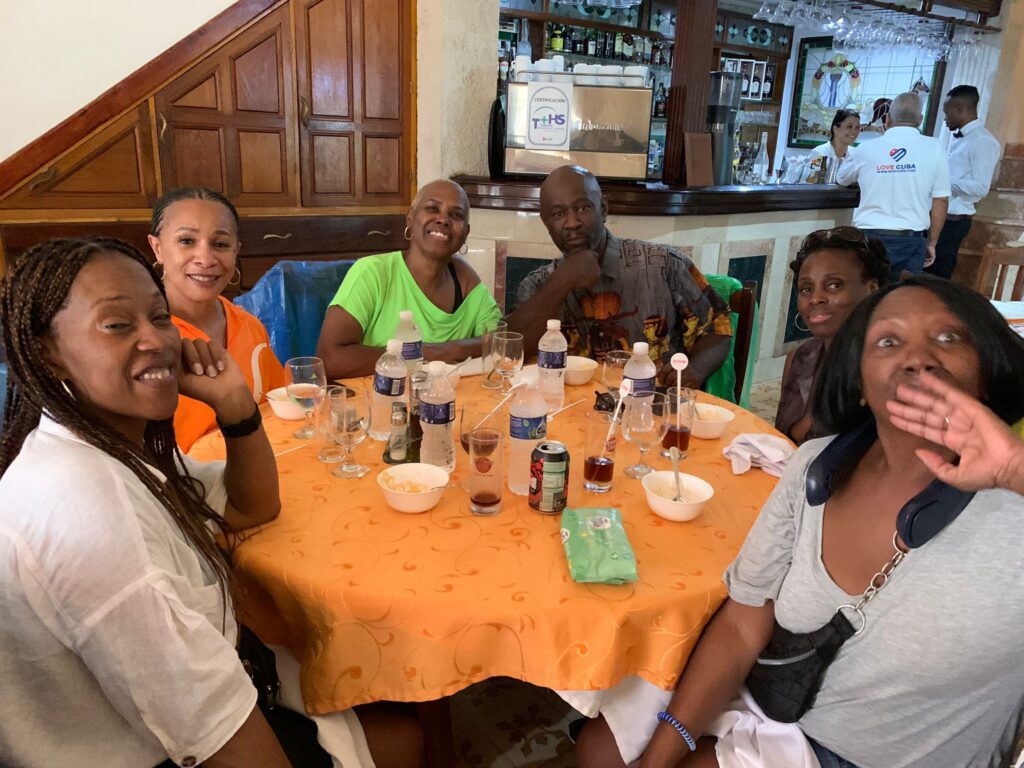 Travellers pose whilst at lunch during Havana classic car tour
