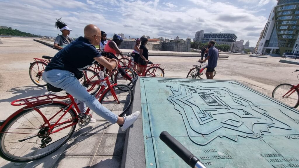 Travellers stop at map during Havana bike ride tour