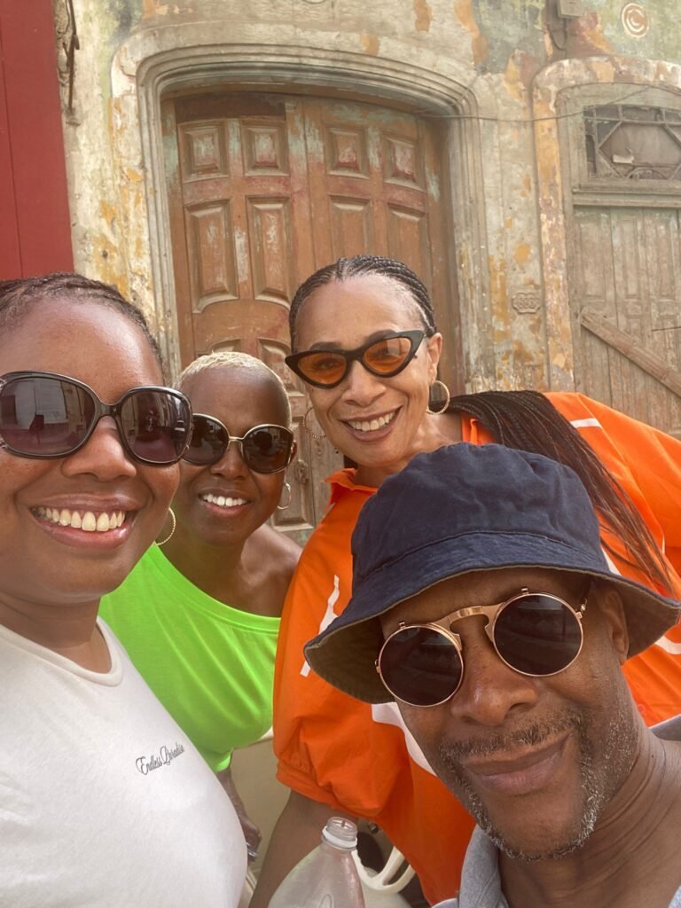 Travellers pose during classic Cuban convertible car Havana tour