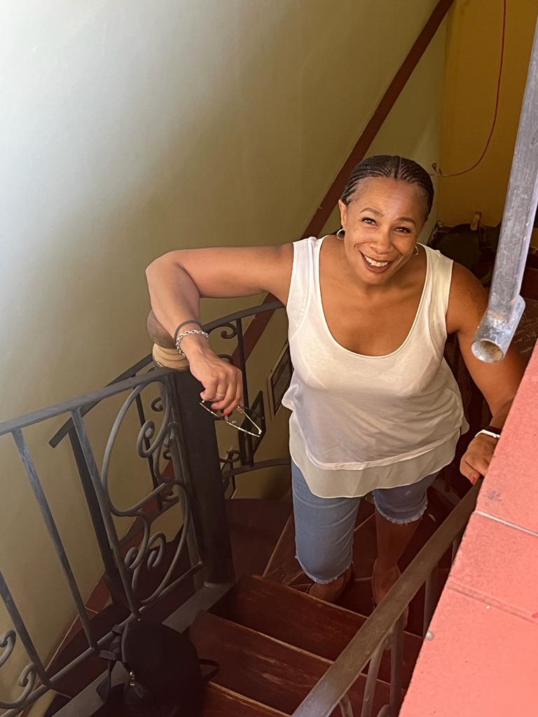 Dee poses inside Casa Chez Nous in Havana